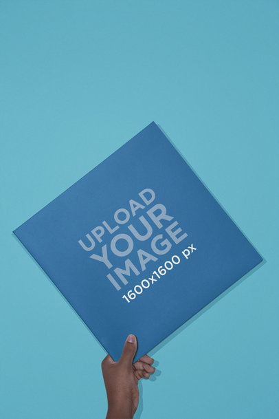 Vinyl Album Cover Mockup Held Over a Solid Background 22118