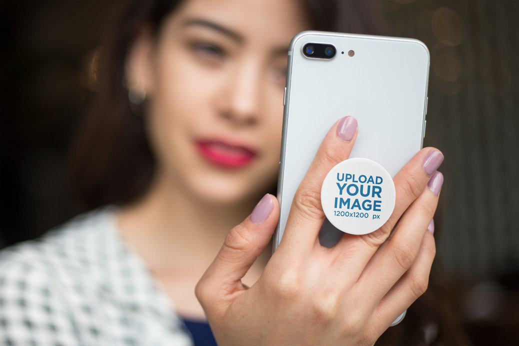 Phone Grip Mockup Held by a Woman Staring at Her Screen