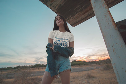 Camping T-Shirt Mockup Featuring a Pretty Woman Posing Outdoor in a Denim-On-Denim Outfit 