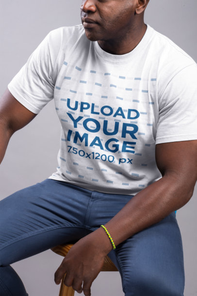 T-Shirt Mockup Featuring Man Wearing a Yellow and Green Bracelet
