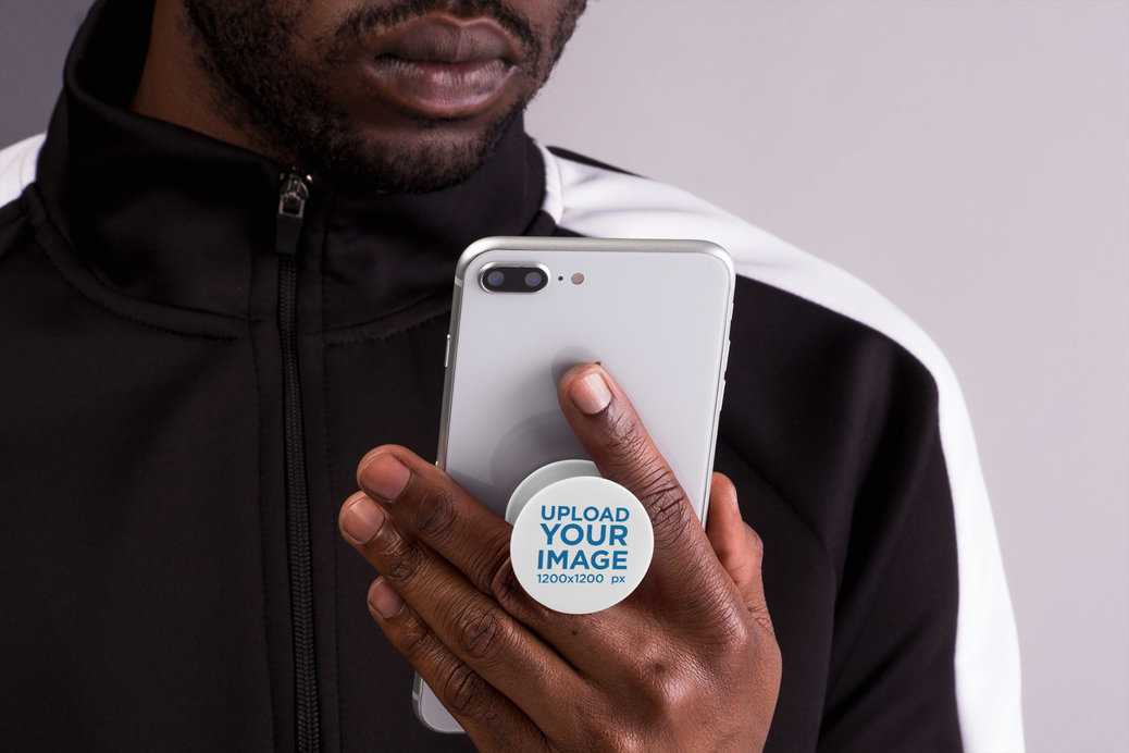 Phone Grip Mockup Featuring a Man Looking at His Smartphone