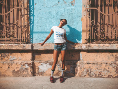 T-Shirt Mockup of a Woman in Front of an Aging Building