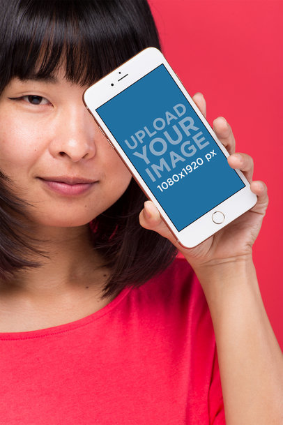 Gold iPhone 8 Plus Mockup Held by a Woman with Bangs
