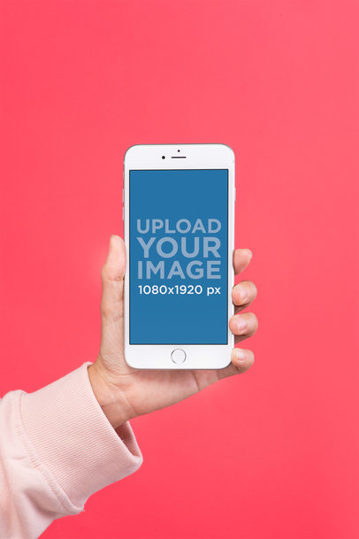 Silver iPhone 8 Plus Mockup Held Over a Salmon Colored Background 22169