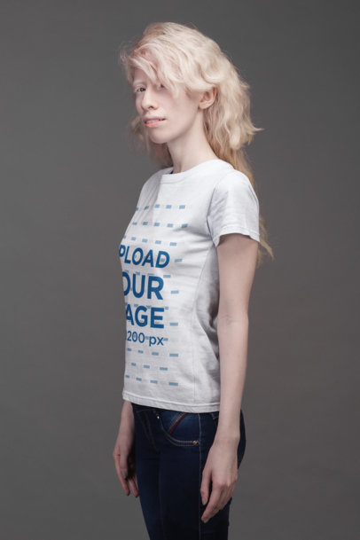 T-Shirt Mockup of a Serious Woman Standing on a Gray Background 