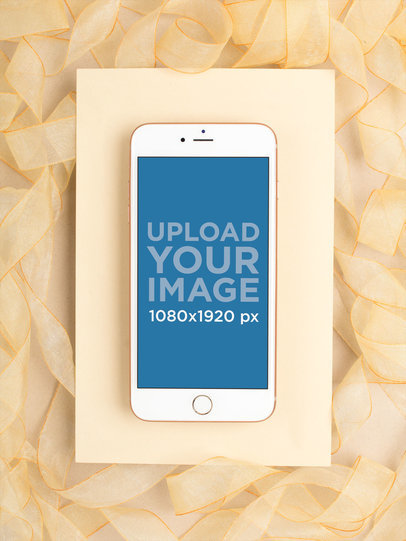 Gold iPhone 8 Mockup Lying on a Surface Decorated with Gold Organza Ribbon 22185