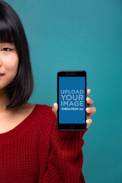 Mockup Showing a Space Gray iPhone 8 Plus Being Held Against a Dark Cyan Background