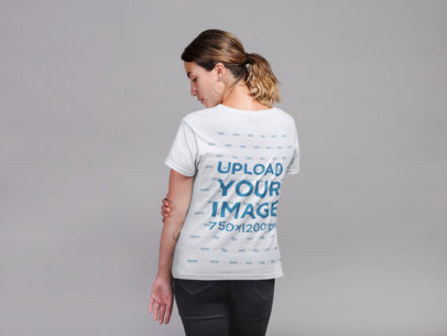 Back Shot T-Shirt Mockup of a Woman with a Low Ponytail and Hoop Earrings 21301