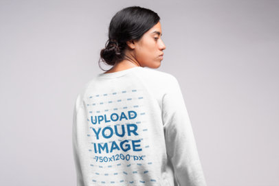 Back View Sweatshirt Mockup of a  Serious Woman with a Messy Hair Bun
