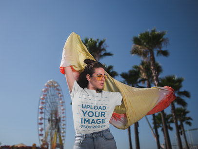 Mockup of a Woman Wearing a T-Shirt in a Desert Festival Setting