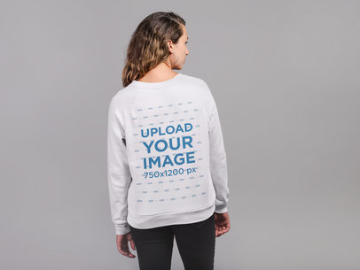 Back View Sweatshirt Mockup Featuring a Woman Against a Gray Wall 