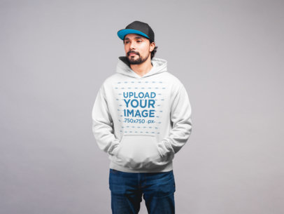Pullover Hoodie Mockup Featuring a Man with a Beard Wearing a Hip-Hop Cap