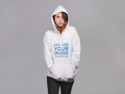 Mockup of a Woman Wearing a Pullover Hoodie with a Serious Look