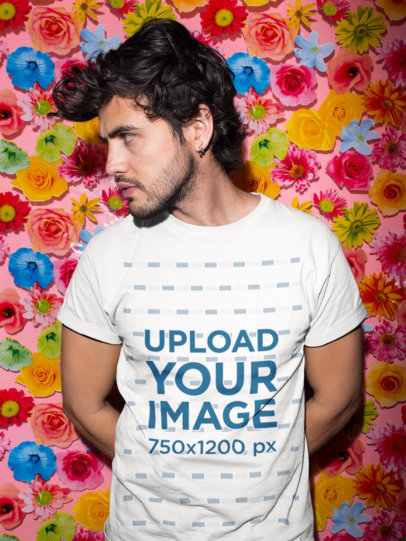 Mockup of a Man Wearing a Tshirt Standing Against a Tablecloth with Flowers 18751