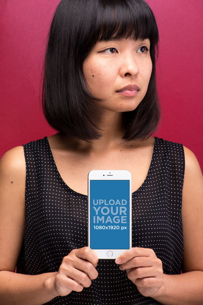 Mockup of an iPhone 8 Plus Held by a Woman With a Beauty Mark 22178
