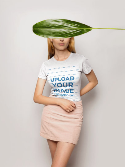 T-Shirt Mockup of a Female Model with Her Face Covered with a Green Leaf