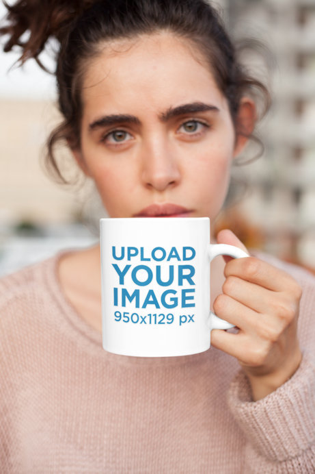 Mockup of a Coffee Mug Held by a Woman with a Messy Bun