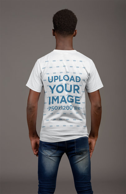Back View T-Shirt Mockup of a Thin Man Against a Flat Gray Wall 