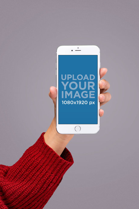 Silver iPhone 8 Mockup Held by Someone Wearing a Red Knit Sweater