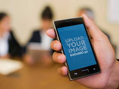 Mockup of a Man Holding an LG Optimus L5 in a Vertical Position 35011