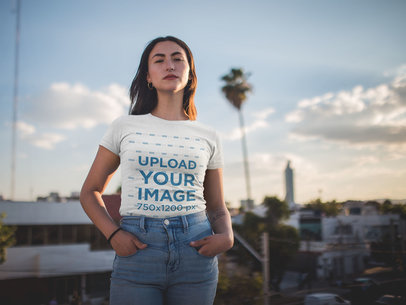 T-Shirt Mockup of a Woman Standing in Front of a City Skyline