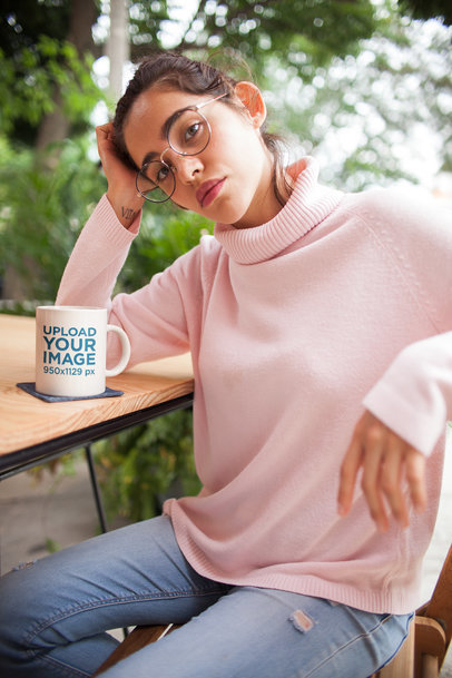 Mockup of a Coffee Mug Next to a Woman with a Wrist Tattoo 22424