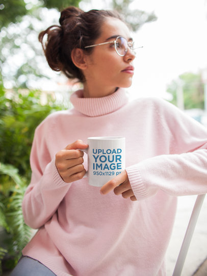 Mockup of a Coffee Mug Held by a Woman Wearing a Turtleneck Sweater