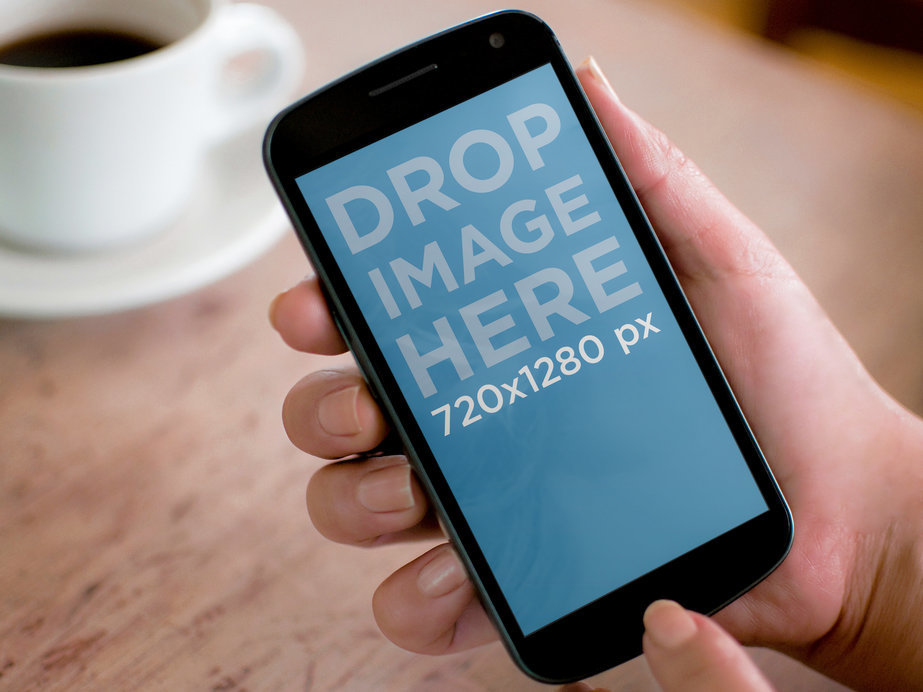 Mockup of a Man with a Google Nexus 4 Featuring a Coffee Cup