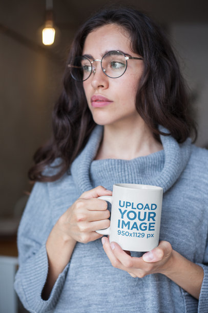 Coffee Mug Mockup Featuring a Woman Wearing a Turtleneck Sweater and Round Glasses