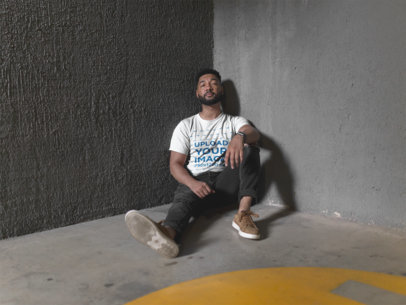 Crewneck Tee Mockup of a Bearded Man Sitting Against a Cement Wall  21349