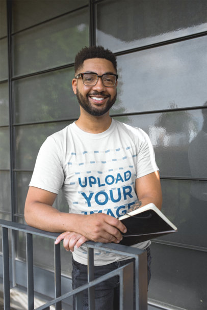 T-Shirt Mockup of a Man with a Leather Bound Notebook 21354