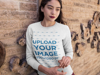 Crewneck Sweatshirt Mockup of a Woman Leaning on a Textured Wall
