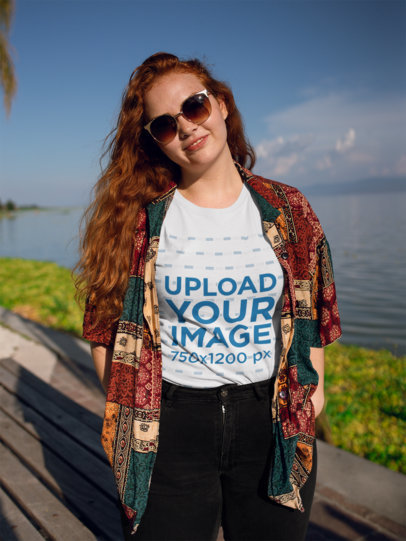 Roundneck Tee Mockup of a Woman in a Vintage Outfit Posing by a Lake