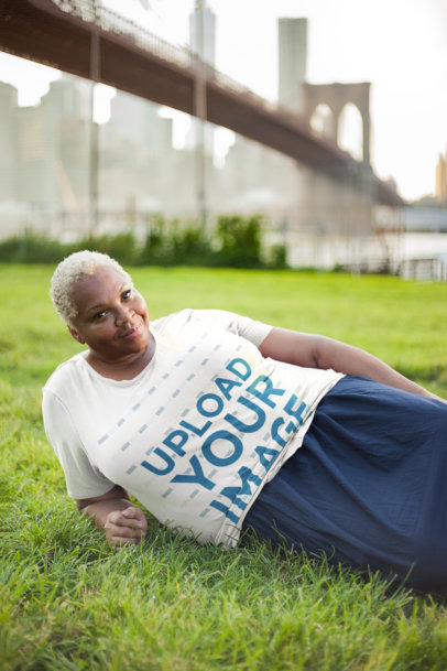 Mockup of a Woman Wearing a Plus Size T-Shirt Lying on Grass