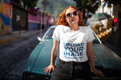 T-Shirt Mockup Featuring a Woman Casually Leaning on an Old Car 
