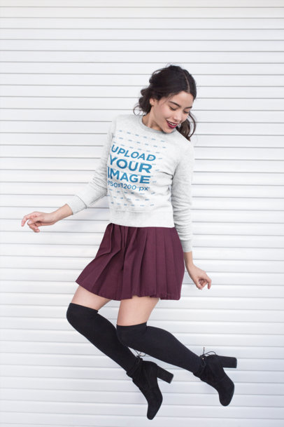 Sweatshirt Mockup Featuring a Woman in a Trendy Outfit Jumping 