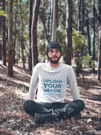 Front View Sweater Mockup of a Man Sitting in the Woods