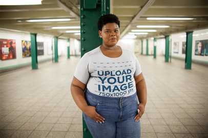 Mockup of a Woman Wearing a Plus Size Tshirt at a Subway Station