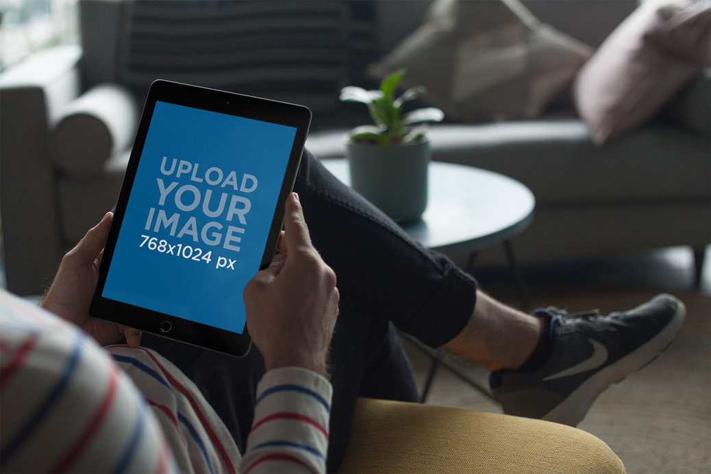 iPad Mockup Held in A Living Room Setting