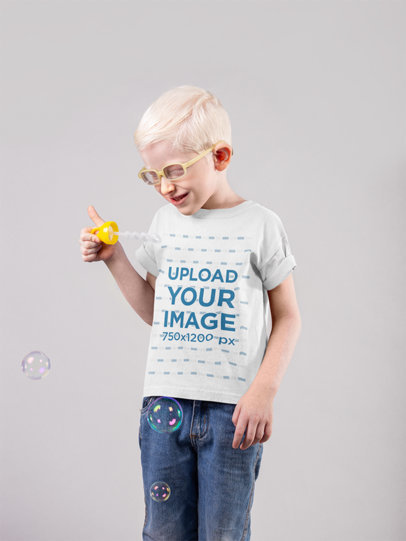 Mockup of a Little Boy Wearing a T-Shirt and Happily Blowing Bubbles 22061