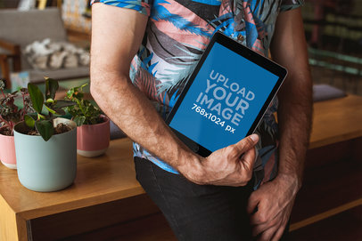 Space Gray iPad Mockup Being Held by a Man with a Printed Shirt 22600