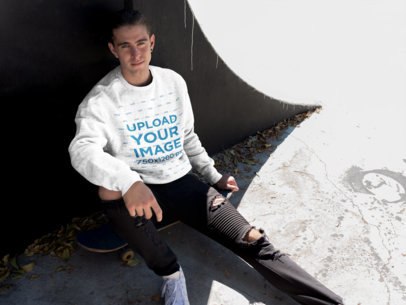 Sweatshirt Mockup Featuring a Cool Man Sitting on His Skateboard