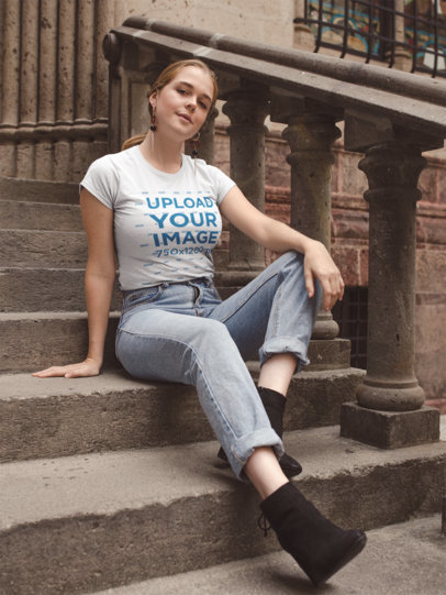 Round Neck T-Shirt Mockup of a Woman Sitting on a Stone Stairway