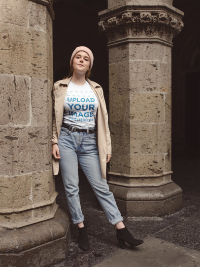 T-Shirt Mockup Featuring a Woman Outside a Stone Church
