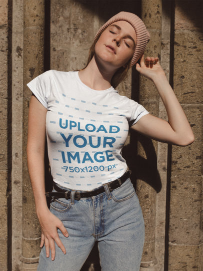 Tshirt Mockup of a Woman Posing Outside a Stone Church