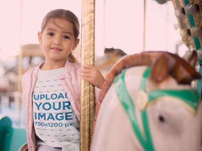 Mockup of a Little Girl Riding a Carousel Horse Wearing a Tshirt 