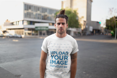 T-Shirt Mockup Featuring a Man with a Man-Bun Hairstyle and a Tattoo