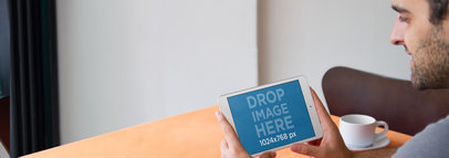Tablet Mockup Featuring a Man Using an iPad at a Restaurant 