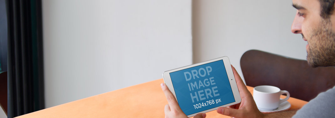 Tablet Mockup Featuring a Man Using an iPad at a Restaurant 