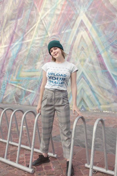 T-Shirt Mockup Featuring a Woman in Front of Street Art